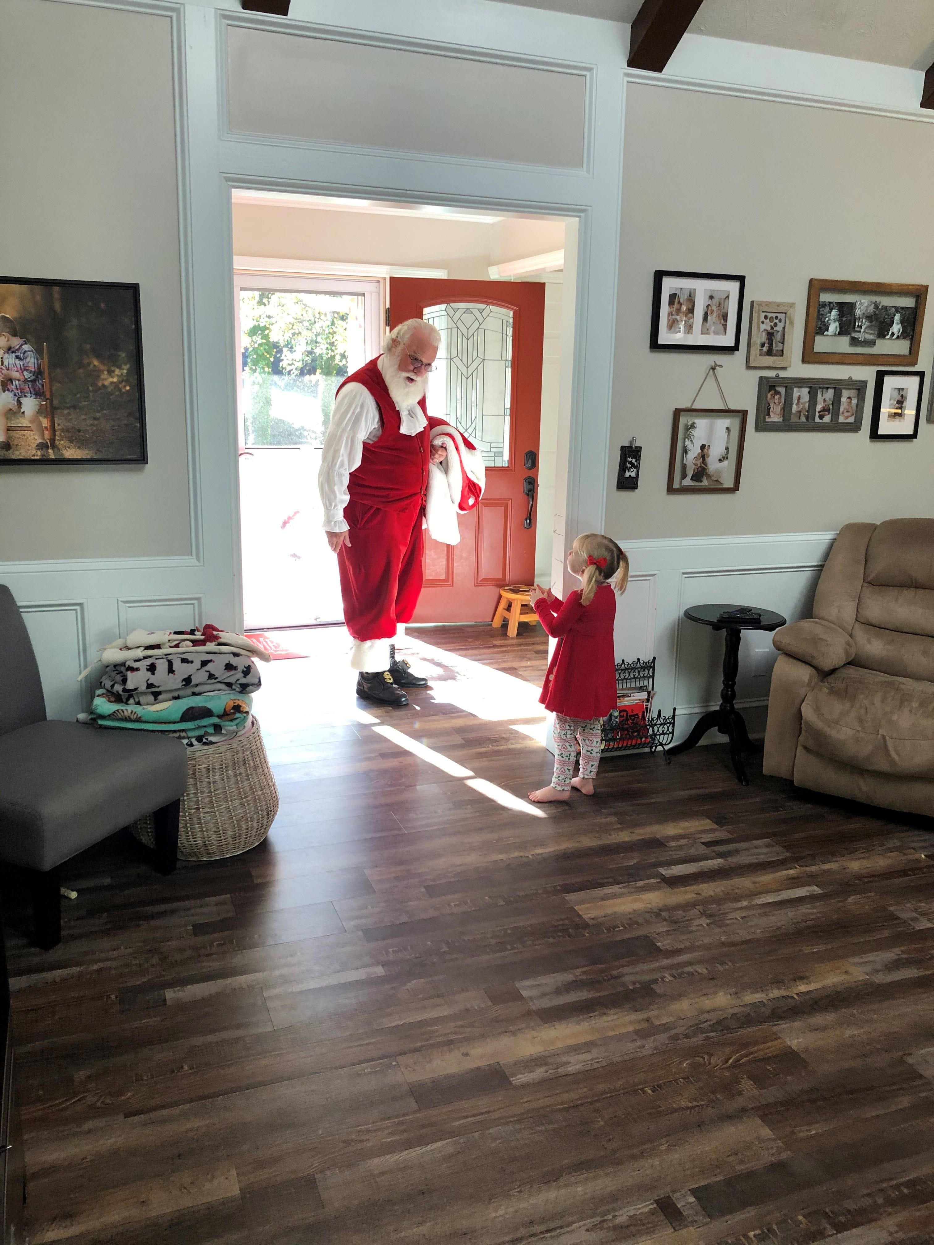 A Kid and Santa by the Door